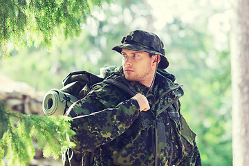 Image showing young soldier with backpack in forest