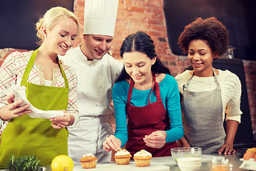 Image showing happy women and chef cook baking in kitchen