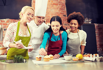 Image showing happy women and chef cook baking in kitchen