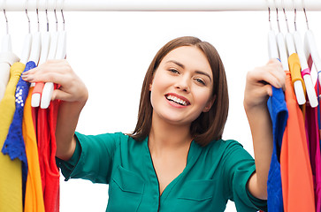 Image showing happy woman choosing clothes at home wardrobe