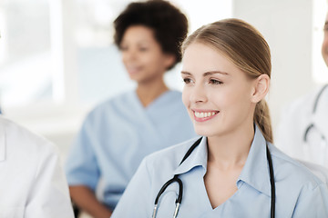 Image showing happy doctor over group of medics at hospital