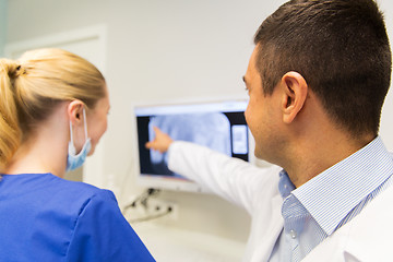 Image showing close up of dentist and assistant at dental clinic