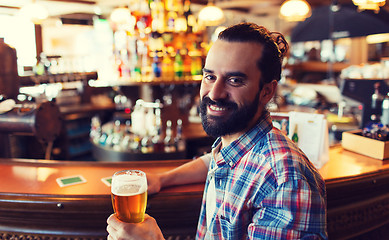 Image showing happy man drinking beer at bar or pub