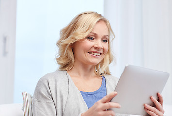 Image showing happy middle aged woman with tablet pc at home