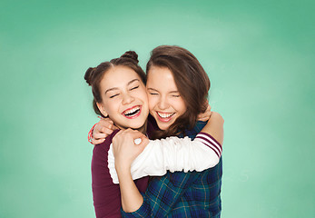 Image showing happy smiling teenage student girls hugging