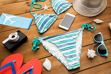 Image showing close up of smartphone and beach stuff