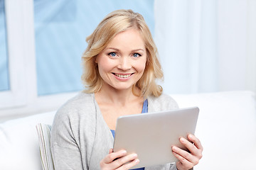 Image showing happy middle aged woman with tablet pc at home