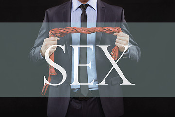 Image showing man in business suit with chained hands. handcuffs for sex games. concept of erotic entertainment. sex