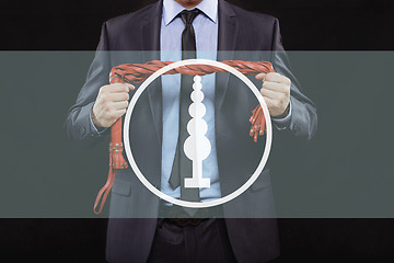 Image showing man in business suit with chained hands. handcuffs for sex games. concept of erotic entertainment.