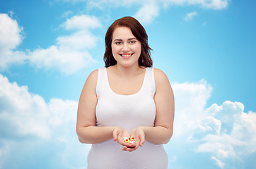 Image showing happy plus size woman in underwear with pills