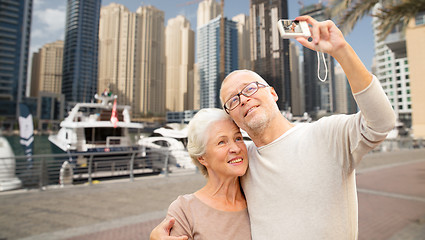 Image showing senior couple taking selfie with camera at harbor