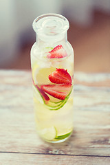 Image showing close up of fruit water in glass bottle