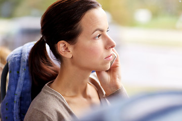 Image showing woman in travel bus calling on smartphone