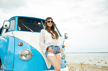 Image showing smiling young hippie woman with minivan car