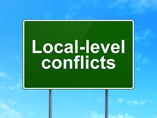 Image showing Politics concept: Local-level Conflicts on road sign background