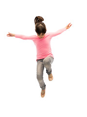 Image showing happy little girl jumping in air