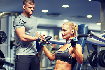 Image showing man and woman flexing muscles on gym machine