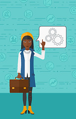 Image showing Business woman pointing at cogwheels.