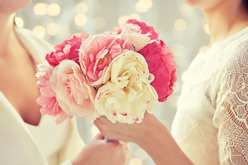 Image showing close up of happy lesbian couple with flowers