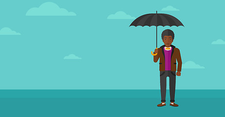 Image showing Businessman standing with umbrella.