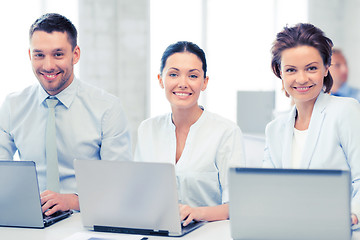 Image showing group of people working with laptops in office