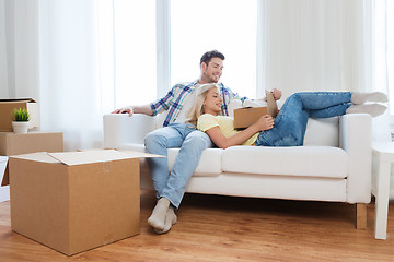 Image showing happy couple with big cardboard boxes at new home