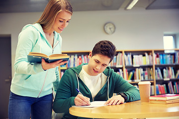 Image showing happy students preparing to exams in library