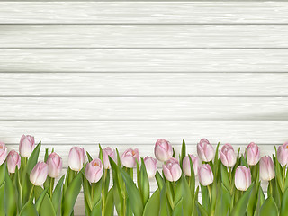 Image showing Pink tulips on wooden background. EPS 10