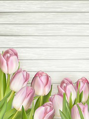 Image showing Color tulips on wooden background. EPS 10