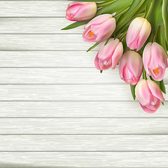 Image showing Pink tulips on wooden background. EPS 10