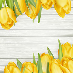 Image showing Fresh yellow tulips on wooden background. EPS 10
