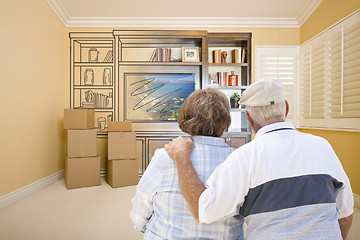 Image showing Senior Couple Looking At Drawing of Entertainment Unit In Room