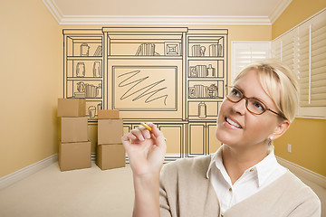 Image showing Female Holding Pencil In Room With Drawing of Entertainment Unit