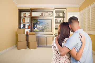 Image showing Young Couple Looking At Drawing of Entertainment Unit In Room