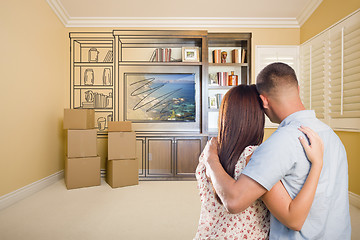 Image showing Young Couple Looking At Drawing of Entertainment Unit In Room