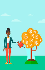 Image showing Woman watering money tree.