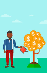 Image showing Man watering money tree.