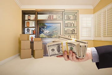 Image showing Holding Out Cash Over Drawing of Entertainment Unit In Room