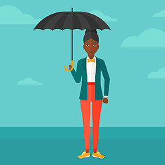 Image showing Business woman standing with umbrella.