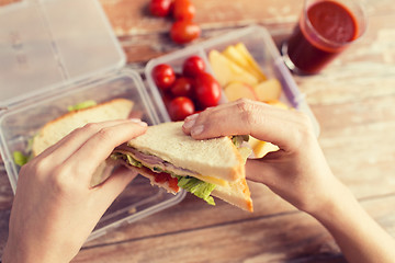 Image showing close up of woman with food in plastic container