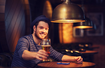 Image showing happy man drinking beer at bar or pub