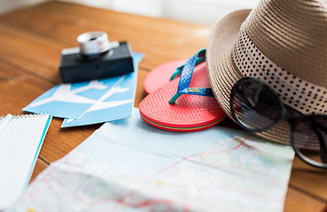 Image showing close up of travel map, flip-flops, hat and ticket