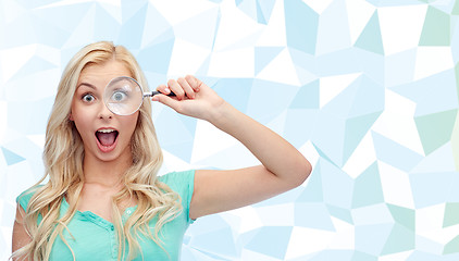 Image showing happy young woman with magnifying glass