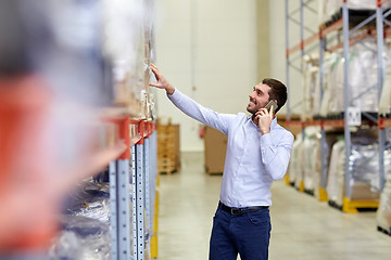 Image showing happy man calling on smartphone at warehouse
