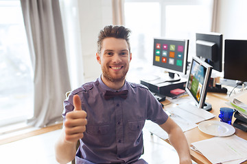 Image showing happy male office worker showing thumbs up