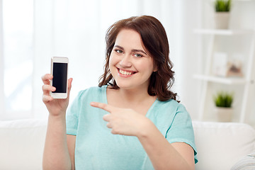 Image showing happy plus size woman with smartphone at home