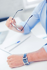 Image showing businessman with spectacles writing in notebook