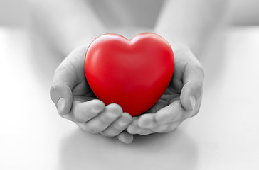 Image showing close up of child hands holding red heart