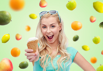 Image showing happy young woman in sunglasses eating ice cream