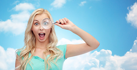 Image showing happy young woman with magnifying glass